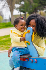 African mother and kid having fun in a park