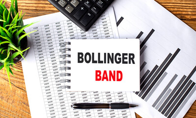 BOLLINGER BAND text on notebook on chart with calculator and pen