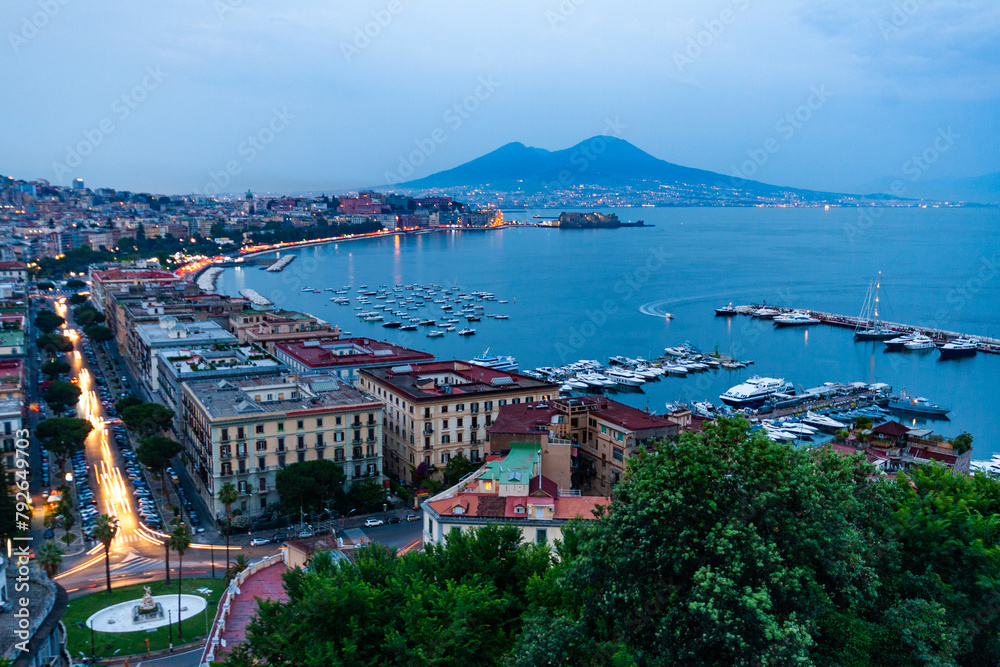 Wall mural night view of naples with vesuvius mount