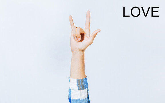 Hand gesturing LOVE in sign language. Hand of man gesturing LOVE in sign language