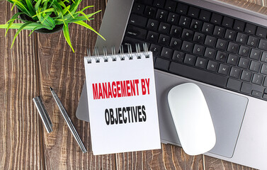MANAGEMENT BY OBJECTIVES text on notebook with laptop, mouse and pen