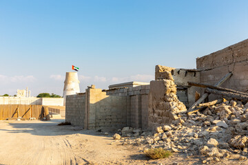 Abandoned demolished building of Al Jazirah Al Hamra town in United Arab Emirates, old ruins of...