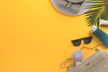 Traveler accessories with straw hat, sunglasses and fan on yellow background. Summer and travel concept