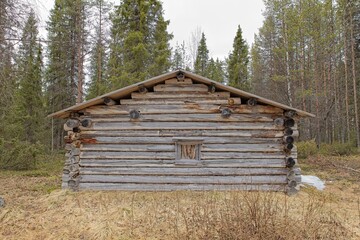 Old log cabin in cloudy spring weather at Riutukka Log Floating Museum, Salla, Lapland, Finland.