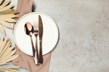 Setting with beautiful cutlery on textured table, top view. Space for text