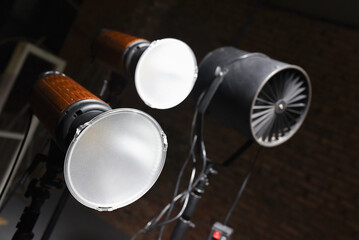 Photostudio led constant light sources and axial fan on the brick wall background. Photo studio equipment.