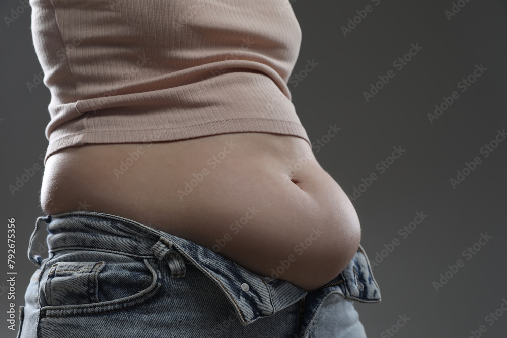 Canvas Prints Woman with excessive belly fat on grey background, closeup. Overweight problem