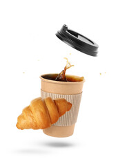 Cup of splashing coffee and fresh croissant flying on white background