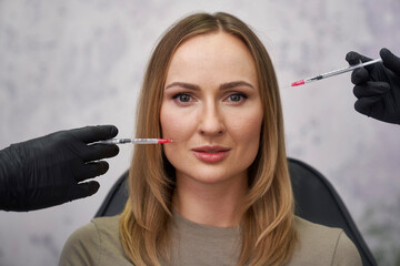 Portrait of woman among syringes