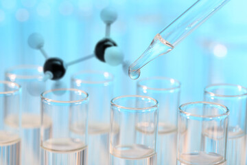 Test tubes and molecule model in laboratory, closeup