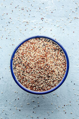 Quinoa mix. Mixed white, red and black quinoa seeds in a bowl, shot from above