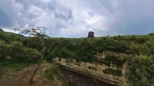 Woman hiking through Hell&rsquo;s gate national park in Kenya
