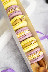 Macaroons with different fillings in a box close-up.