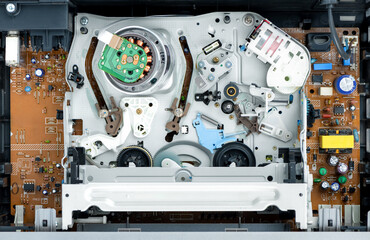VHS video recorder inside without video cassette, view of the tape mechanism. Top view.