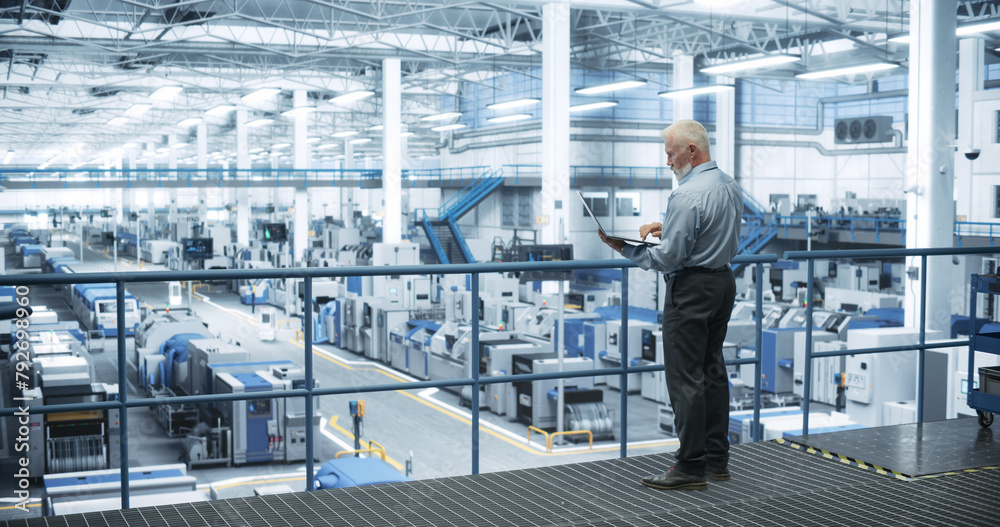 Poster Thoughtful Middle Aged Engineer Monitoring and Analyzing Conditions at a Pristine Modern Electronics Factory with Automated Mobility Robots Working with the Help of Artificial Intelligence Software