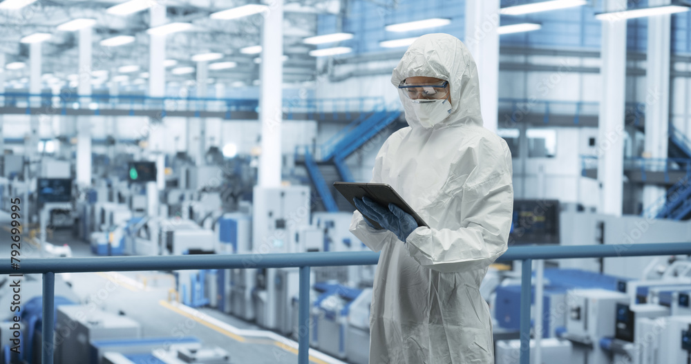 Aufkleber industrial scientist wearing disposable protective suit, mask and goggles at a production plant. fem