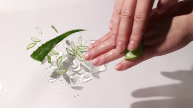 Aloe drops fall and moisturize the skin of female hands. High quality 4k footage