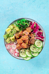 Tuna poke bowl with avocado, cucumbers, wakame, radish, and purple cabbage, a healthy Hawaiian dish...