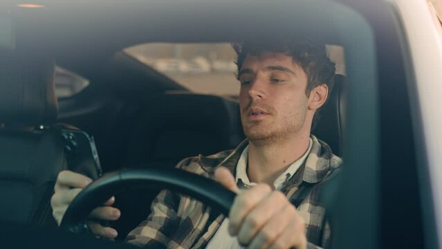 Sad Caucasian man auto driver inside car on parking lot displeased frustrated male businessman using mobile phone read bad news smartphone message upset anxious stressed guy driving travel in city