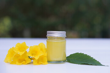 Bottle of homemade Thai herbal ointment, balm.Decorated with yellow flower.Concept, Thai local...