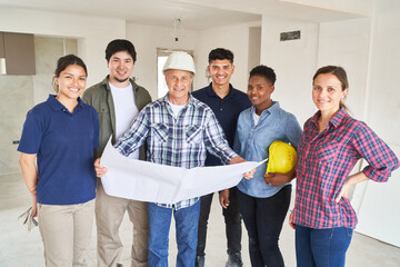 Portrait of smiling coworkers and contractor with blueprint discussing in meeting