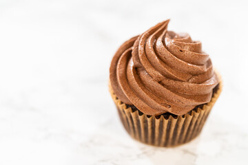 Baking Chocolate Cupcakes with Decadent Chocolate Frosting - 792721719