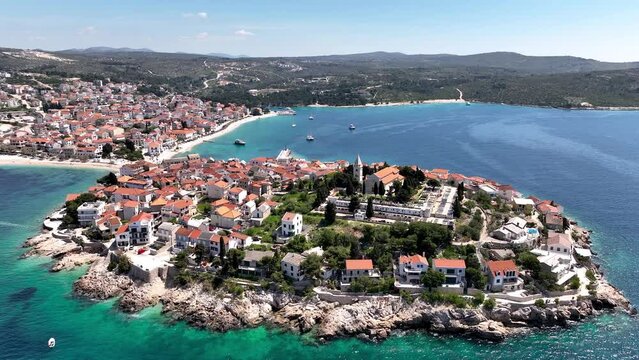 Aerial panoramic video with scenic town of Primosten in Croatia, famous and picturesque tourist resort at Adriatic sea coast