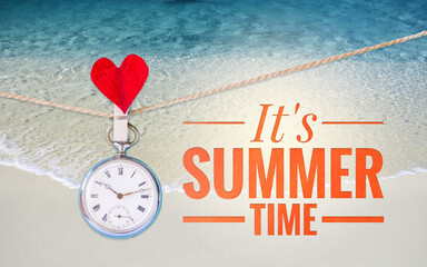 It's summer time with vintage pocket watch over clear sandy beach, summer season background