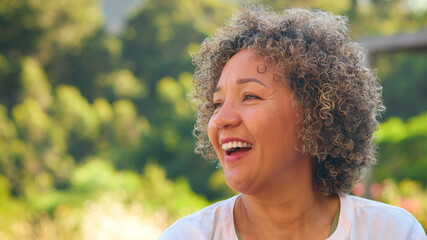 Portrait Of Laughing And Smiling Mature Woman Standing Outdoors In Countryside