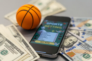 Sports betting website in a mobile phone screen, ball, money - 792734118