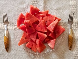 slices of watermelon on plate with fork