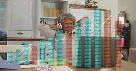 Image of financial data processing over senior african american woman using laptop