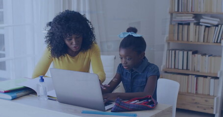 Image of data over happy african american mother and daughter using laptop for school homework