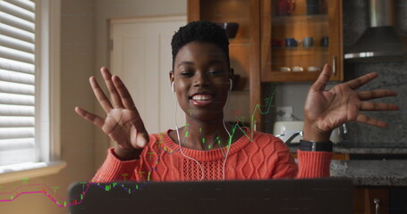 Image of financial data processing over african american woman using laptop