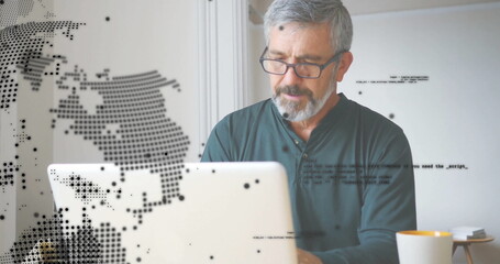 Image of global network over senior caucasian man in glasses using laptop at home