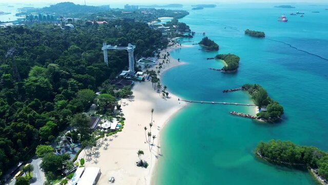 Aerial drone landscape of Sentosa Island Siloso harbour beachfront cable car sandy ocean bungee jump Singapore recreation Asia travel tourism