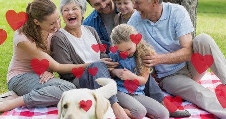Image of heart icons floating over pet dog with caucasian family