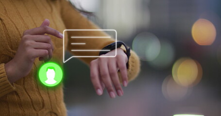 Image of neon profile and message icon over mid section of a woman using smartwatch