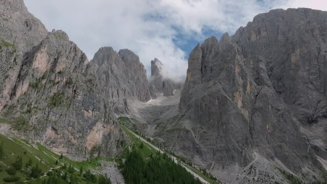 Aerial parallax effect view of the Sasmujel limestone mountain near Santa Cristina. The drone is slowly moving from left to right revelaing the mountain. Dolomites, South Tyrol, Italy. LuPa Creative