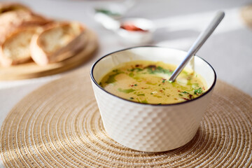 Bowl of potato soup with parsley and bacon with toasted bread croutons in white bowl. Comfort meal