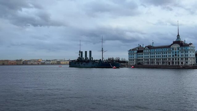 St. PETERSBURG, RUSSIA - April 20, 2024: The Aurora Cruiser Museum on the Neva River on a 20th-century warship. View of the cruiser Aurora, a historical warship, now a war memorial museum. 4К