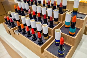 Stands with variety of different color lipsticks, professional women cosmetics. top view from above