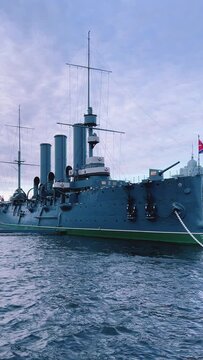 St. PETERSBURG, RUSSIA - April 20, 2024: The Aurora Cruiser Museum on the Neva River on a 20th-century warship. View of the cruiser Aurora, a historical warship, now a war memorial museum. 4К