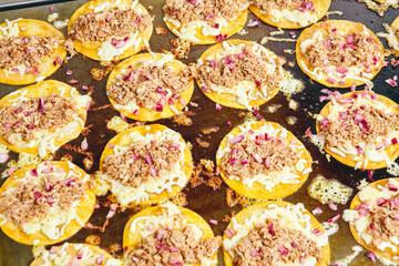 Frying tacos tortillas with cheese and meat on griddle in professional kitchen in restaurant. Mexican cuisine, Latin American fast food