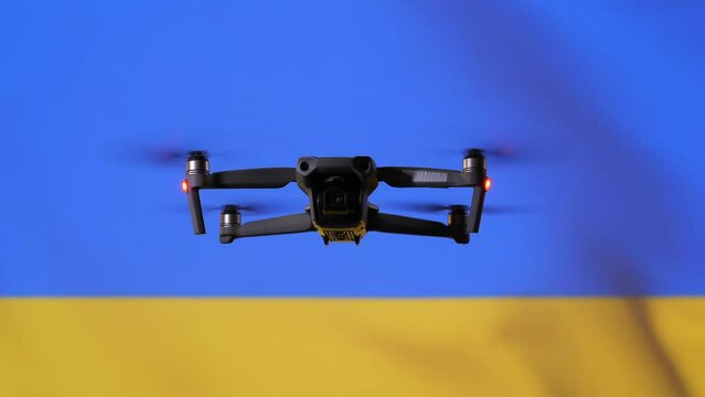 close-up drone flies against the background of the Ukrainian flag, drones at war