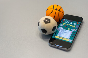 Sports betting website in a mobile phone screen, ball, money - 792754135