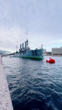 St. PETERSBURG, RUSSIA - April 20, 2024: The Aurora Cruiser Museum on the Neva River on a 20th-century warship. View of the cruiser Aurora, a historical warship, now a war memorial museum. 4К
