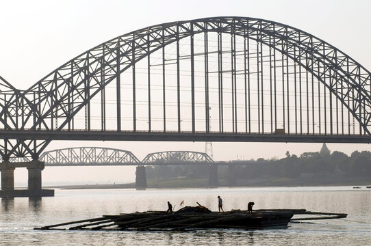 Myanmar (burma) sunset at mandalay harbour with bridges on background on the irrawady river near sagaing, mandalay