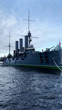 St. PETERSBURG, RUSSIA - April 20, 2024: The Aurora Cruiser Museum on the Neva River on a 20th-century warship. View of the cruiser Aurora, a historical warship, now a war memorial museum. 4К