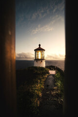 Sunrise Looking Through a Fence at a Lighthouse in Hawaii